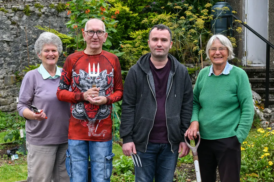 Fairoak tenants and helpers in a garden in Kendal, Cumbria