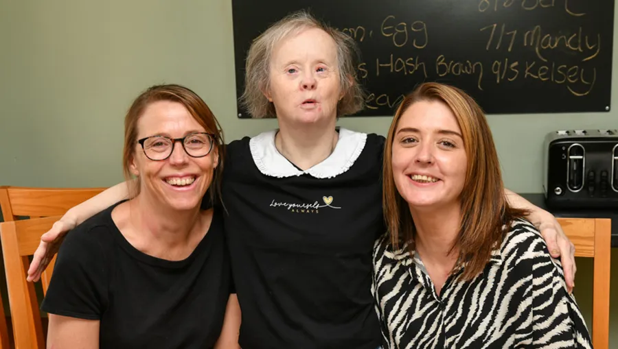 Supported housing workers with a tenant with a learning disability in her home
