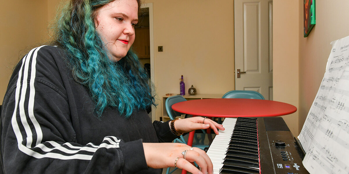 Lily-Beck-Fairoak-Housing A tenant of Fairoak Housing Association playing piano in her home in Kendal